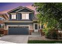 Charming two-story home featuring a two-car garage, brick accents, and professional landscaping at 10647 Nucla St, Commerce City, CO 80022