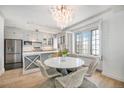Kitchen and dining area with stainless steel appliances, marble countertops and decorative chandelier at 99 S Downing St # 605, Denver, CO 80209
