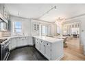 Modern white kitchen featuring stainless steel appliances and open to the dining area at 99 S Downing St # 605, Denver, CO 80209