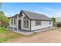 Modern home with clean white siding, contrasting trim and a well-kept front yard at 1100 Urban St, Lakewood, CO 80401