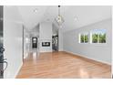 Bright open floor plan featuring hardwood floors and an eye-catching modern light fixture at 1100 Urban St, Lakewood, CO 80401
