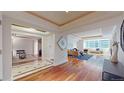 Bright living room featuring gleaming hardwood floors, a large window, and stylish contemporary furnishings at 1891 Curtis St # 1613, Denver, CO 80202