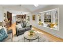 Bright living room featuring a bay window, hardwood floors, and comfortable seating at 3790 E Geddes Ave, Centennial, CO 80122