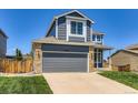 Charming two-story home with a gray exterior, a gray garage door, and a well-kept green lawn at 5663 W 118Th Pl, Westminster, CO 80020