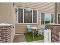 Small front patio with table and chairs, perfect for relaxing at 15476 W 64Th Loop # C, Arvada, CO 80007