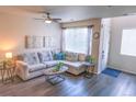 Open living room showcasing a sectional sofa and entryway at 15476 W 64Th Loop # C, Arvada, CO 80007