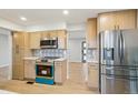 Bright kitchen with stainless steel appliances, modern cabinetry and a beautiful backsplash design at 9435 Osceola St, Westminster, CO 80031