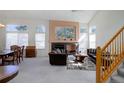 Bright living room featuring a fireplace, staircase, vaulted ceilings and lots of natural light at 2608 S Troy Ct, Aurora, CO 80014