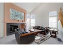 Cozy living room featuring a fireplace with tile surround, large window and comfortable seating at 2608 S Troy Ct, Aurora, CO 80014
