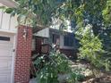 Charming covered front porch and brick facade creates a warm, inviting entrance at 12682 W Louisiana Ave, Lakewood, CO 80228