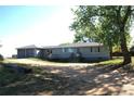 Ranch home with attached two-car garage, large yard, and mature trees, offering comfortable suburban living at 6363 County Road 20, Longmont, CO 80504