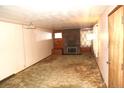 Cozy living room with a brick fireplace, carpet, and large window for natural light at 6363 County Road 20, Longmont, CO 80504