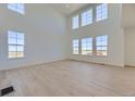 Bright, spacious living room with soaring ceilings, many large windows and hardwood-style flooring at 39896 Floyd St, Elizabeth, CO 80107