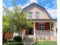 Two-story home with a large front porch and brick facade at 3409-3415 W Moncrieff Pl, Denver, CO 80211