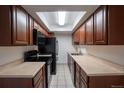 Efficient kitchen with ample cabinetry, modern appliances, and a bright skylight for natural lighting at 8330 Zuni St # 214, Denver, CO 80221
