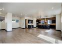 Open concept living area boasts hardwood floors and ample natural light at 1778 Peak Loop, Broomfield, CO 80023
