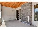 Patio with stone fireplace offers a cozy outdoor space for relaxing and entertaining at 1778 Peak Loop, Broomfield, CO 80023
