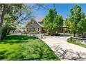 Well maintained two story home with mature shade trees and a circular driveway at 1300 W Caley Ave, Littleton, CO 80120