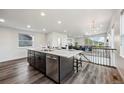 Kitchen island with marble countertop and seating adjacent to open living space at 260 Upper Glenway Rd, Palmer Lake, CO 80133