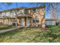 Cozy townhome with brick exterior, small porch, and well-kept lawn, perfect for relaxed outdoor enjoyment at 4509 Everett St, Wheat Ridge, CO 80033