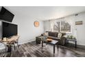 Inviting living room with wood-look floors, stylish furniture, and natural light, creating a warm ambiance at 4509 Everett St, Wheat Ridge, CO 80033
