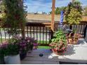 Back porch with flowers, and a view of a field beyond a wooden fence on a sunny day at 475 Hampstead Ave, Castle Rock, CO 80104