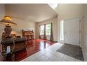 Inviting foyer with a combination of hardwood and tile flooring, large windows, and a view into the spacious living room at 475 Hampstead Ave, Castle Rock, CO 80104