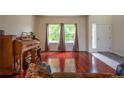Bright and airy living room with hardwood floors, large windows, and comfortable seating, filled with natural light at 475 Hampstead Ave, Castle Rock, CO 80104