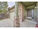 Welcoming front entrance featuring stone pillars, house number, and a cozy welcome mat at the front door at 17484 E 99Th Ave, Commerce City, CO 80022