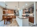 Beautiful kitchen with a dining area, stainless steel appliances, plenty of storage, and lots of light at 17484 E 99Th Ave, Commerce City, CO 80022