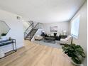 Bright living room with neutral decor, sleek flooring, and a modern staircase at 3061 W 92Nd Ave # 2D, Westminster, CO 80031