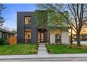 Modern two-story home with a dark brick accent, manicured lawn, and a inviting front entrance at 1601 S Columbine St, Denver, CO 80210