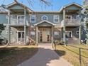 Charming two-story condo with balconies, brick accents, and well-maintained lawn at 5335 Pecos Way # 4, Denver, CO 80221