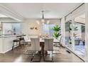Dining area with modern lighting, a large table, and sliding doors to the outside at 1382 Braewood Ave, Highlands Ranch, CO 80129