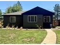 Charming home with manicured front lawn, and modern windows, creating inviting and comfortable curb appeal at 1560 Quince St, Denver, CO 80220