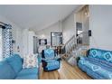 Bright living room features hardwood floors and comfy blue couches at 3742 S Danube Cir, Aurora, CO 80013