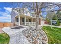 Attractive home featuring a covered porch, stone landscaping, and a walkway at 13325 W 86Th Dr, Arvada, CO 80005