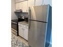 Modern kitchen with stainless steel appliances, granite countertops, and white cabinetry at 7495 E Quincy Ave # 205, Denver, CO 80237