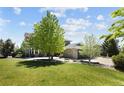 Landscaped lawn featuring an exterior view of the home with stone accents and a spacious backyard at 14712 Kalamath Ct, Westminster, CO 80023