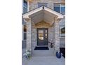 Close up of the front door with pillars and covered entryway at 14712 Kalamath Ct, Westminster, CO 80023