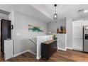 Hallway area with neutral paint, luxury vinyl flooring, and staircase to lower level at 19437 E Mann Creek Dr # A, Parker, CO 80134