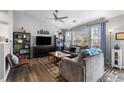 Bright living room featuring modern decor, ample seating, and large windows with natural light at 19437 E Mann Creek Dr # A, Parker, CO 80134