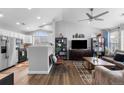 Open-concept living room with high ceilings, wood floors, and plenty of natural light at 19437 E Mann Creek Dr # A, Parker, CO 80134