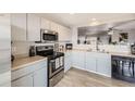 Updated kitchen with stainless steel appliances and a view into the living room at 11009 Gaylord. St, Northglenn, CO 80233