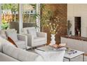 Bright living room with exposed brick fireplace and cozy seating arrangement at 8955 E 19Th Ave, Aurora, CO 80010