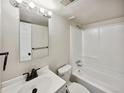 Bright bathroom with a tub and shower combo and a mirrored vanity at 9065 Cody Ct, Broomfield, CO 80021