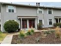 Front view of a townhome with well-maintained landscaping at 1920 S Oswego Way, Aurora, CO 80014