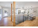 Modern open-concept kitchen featuring stainless steel appliances, a large island, and sleek finishes at 2718 S Langley Ct, Denver, CO 80210