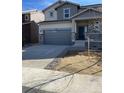 Charming two-story home featuring a stone facade and a two-car garage at 728 N Clubview St, Watkins, CO 80137