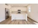 Modern kitchen with stainless steel appliances, large island, and ample cabinet space at 728 N Clubview St, Watkins, CO 80137